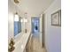 Hallway featuring vanity with mirror and pendant lighting at 1809 Haverford Ave, Sun City Center, FL 33573