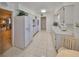 Well-lit kitchen featuring white appliances, tile flooring, and ample counter space at 1809 Haverford Ave, Sun City Center, FL 33573