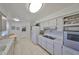 Well-lit kitchen with white appliances, neutral countertops and tile floor at 1809 Haverford Ave, Sun City Center, FL 33573