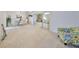 Spacious carpeted living room with sliding door access to another room at 1809 Haverford Ave, Sun City Center, FL 33573