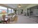 Bright sunroom featuring comfortable seating and sliding door access at 1809 Haverford Ave, Sun City Center, FL 33573