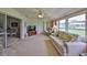 Bright living room featuring a comfortable sofa, armchair, and large windows at 1809 Haverford Ave, Sun City Center, FL 33573