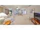 Bright living room with large windows, neutral carpet and decor, and a ceiling fan at 1809 Haverford Ave, Sun City Center, FL 33573
