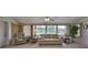 Relaxing living room with a comfortable seating area and large windows at 1809 Haverford Ave, Sun City Center, FL 33573