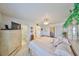 Spacious main bedroom featuring an en-suite bathroom, ceiling fan and closet at 1809 Haverford Ave, Sun City Center, FL 33573