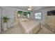 Large main bedroom featuring mirrored wall, ceiling fan and neutral carpet at 1809 Haverford Ave, Sun City Center, FL 33573