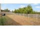 Backyard with a white picket fence, lawn, and mature trees at 2122 Richwood Pike Dr, Ruskin, FL 33570
