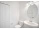 Clean and simple half bathroom with a pedestal sink, toilet, and a mirrored medicine cabinet at 2122 Richwood Pike Dr, Ruskin, FL 33570