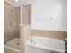 Bright bathroom featuring tile surround soaking tub and a separate tiled shower at 2122 Richwood Pike Dr, Ruskin, FL 33570