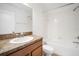 Bathroom featuring single sink vanity, toilet, and shower over tub at 2122 Richwood Pike Dr, Ruskin, FL 33570