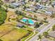 Aerial view shows community pool, playground, and adjacent open green space enhancing neighborhood amenities at 2122 Richwood Pike Dr, Ruskin, FL 33570
