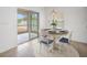 Cozy dining area with a round table, white chairs, and sliding glass doors to the backyard at 2122 Richwood Pike Dr, Ruskin, FL 33570