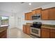 Bright kitchen with stainless steel appliances, granite counters, and access to the backyard patio at 2122 Richwood Pike Dr, Ruskin, FL 33570