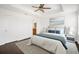 Spacious main bedroom featuring a ceiling fan, ensuite bathroom, and natural light from a window at 2122 Richwood Pike Dr, Ruskin, FL 33570