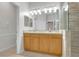 Bathroom featuring double sinks, a large mirror, and a tiled glass-door shower at 215 Oceania Ct, Apollo Beach, FL 33572