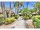 Community gathering space features multiple tiki huts with seating, surrounded by lush landscaping at 215 Oceania Ct, Apollo Beach, FL 33572