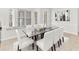 Elegant dining room with a glass table, seating for six, and a window seat for added charm at 215 Oceania Ct, Apollo Beach, FL 33572
