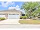 Charming home with a two-car garage, screened-in porch, and well-maintained landscaping at 215 Oceania Ct, Apollo Beach, FL 33572