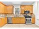 Kitchen boasts stainless steel appliances, light cabinetry, and backsplash at 215 Oceania Ct, Apollo Beach, FL 33572