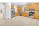 Well-lit kitchen features stainless steel appliances and light wooden cabinetry at 215 Oceania Ct, Apollo Beach, FL 33572