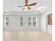Open living room with tiled flooring, recessed lighting, and a series of windows for abundant natural light at 215 Oceania Ct, Apollo Beach, FL 33572