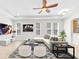 Bright living room features neutral color palette, recessed lighting, and a modern ceiling fan at 215 Oceania Ct, Apollo Beach, FL 33572