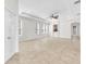 Large open-concept living area with tile floors, neutral walls, and plenty of natural light at 215 Oceania Ct, Apollo Beach, FL 33572