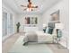 Serene main bedroom with a tray ceiling, featuring a comfortable bed and access to French doors at 215 Oceania Ct, Apollo Beach, FL 33572