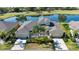Exceptional aerial view of the house showcasing an expansive lake and verdant golf course surroundings at 2246 Sifield Greens Way # 36, Sun City Center, FL 33573