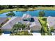Scenic aerial view of the home near a tranquil lake and a lush golf course in the neighborhood at 2246 Sifield Greens Way # 36, Sun City Center, FL 33573