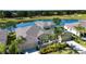 Stunning aerial view of the home, located next to a serene lake and golf course, with palm trees at 2246 Sifield Greens Way # 36, Sun City Center, FL 33573