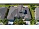 Bird's-eye view of the home near the lake, surrounded by palm trees and lush landscaping at 2246 Sifield Greens Way # 36, Sun City Center, FL 33573