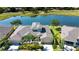 Beautiful aerial view of the property, showing proximity to the tranquil lake and green golf course at 2246 Sifield Greens Way # 36, Sun City Center, FL 33573