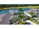 Majestic aerial perspective of this home with a backdrop of a beautiful lake and sprawling golf course at 2246 Sifield Greens Way # 36, Sun City Center, FL 33573