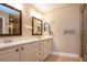 Bathroom with double vanity, neutral walls, tiled flooring, and frameless shower at 2246 Sifield Greens Way # 36, Sun City Center, FL 33573