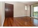 Bedroom featuring hardwood floors, sliding glass doors with lake view, and a bookcase at 2246 Sifield Greens Way # 36, Sun City Center, FL 33573
