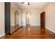 A bedroom featuring hardwood flooring, mirror wardrobe, and a built-in bookcase at 2246 Sifield Greens Way # 36, Sun City Center, FL 33573