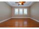 Primary bedroom with wood floors, trey ceiling and three windows for natural light at 2246 Sifield Greens Way # 36, Sun City Center, FL 33573