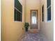 Front entryway featuring a decorative glass door, flanked by two windows, set on brick pavers and potted plant at 2246 Sifield Greens Way # 36, Sun City Center, FL 33573
