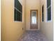 Front entryway featuring a decorative glass door, flanked by two windows, set on brick pavers at 2246 Sifield Greens Way # 36, Sun City Center, FL 33573