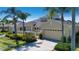 Inviting single-story home featuring a two-car garage, landscaped yard, and gated front courtyard at 2246 Sifield Greens Way # 36, Sun City Center, FL 33573