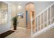 Foyer with decorative glass door, tiled floor, staircase, potted plant and view to a bathroom; dark mat at 2246 Sifield Greens Way # 36, Sun City Center, FL 33573