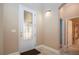 Foyer with decorative glass door, tiled floor, and view to a bathroom; dark mat at 2246 Sifield Greens Way # 36, Sun City Center, FL 33573