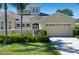 Inviting home featuring a two-car garage, manicured landscaping, and a charming gated front entrance at 2246 Sifield Greens Way # 36, Sun City Center, FL 33573