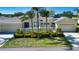 Charming single-story home boasting a well-kept lawn, lush landscaping, and a convenient two-car garage at 2246 Sifield Greens Way # 36, Sun City Center, FL 33573