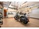 Spacious garage featuring ample storage, cabinets, sink, and a motorcycle parked inside at 2246 Sifield Greens Way # 36, Sun City Center, FL 33573