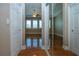View from hallway into bedroom, which features plantation shutters and hardwood floors at 2246 Sifield Greens Way # 36, Sun City Center, FL 33573