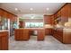 Open kitchen showcases an island with sink, granite countertops, and stainless appliances at 2246 Sifield Greens Way # 36, Sun City Center, FL 33573