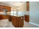 Eat-in kitchen showcasing a kitchen island and stainless steel appliances at 2246 Sifield Greens Way # 36, Sun City Center, FL 33573