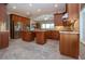 Gourmet kitchen features stainless appliances, island with bar seating and cherry cabinetry at 2246 Sifield Greens Way # 36, Sun City Center, FL 33573
